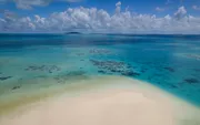 White sandbank surrounded by coral reefs in Ayau, Raja Ampat