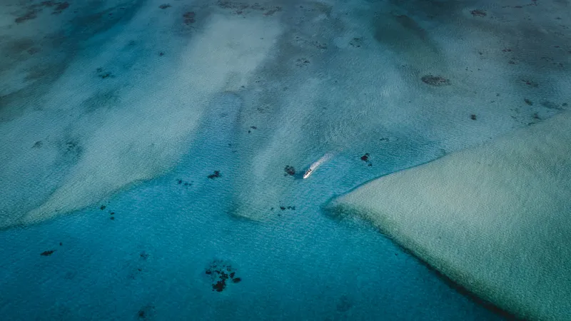 Boat navigating through Ayau's sandbar