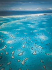 Turquoise lagoon surrounded by coral reefs in the Ayau Archipelago, Raja Ampat