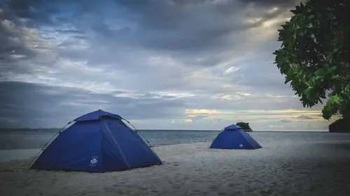 Tents on a white beach in Raja Ampat