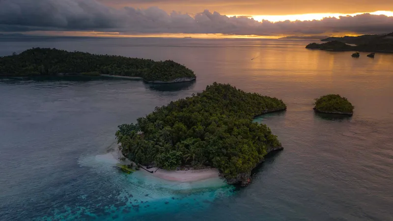 Sun rising over the small islets next to Batanta