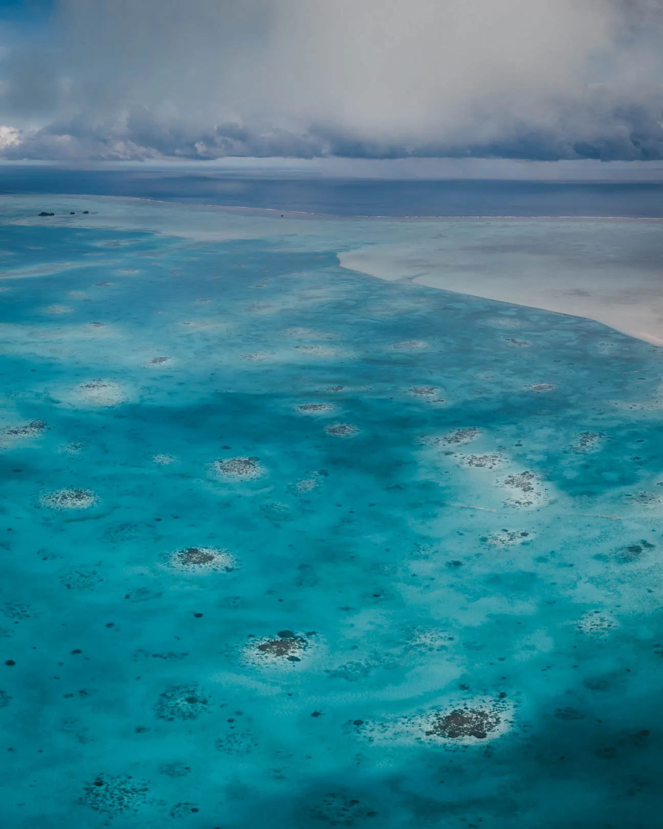 Tropical rainstorm rolling in over the lagoons of Ayau, Raja Ampat