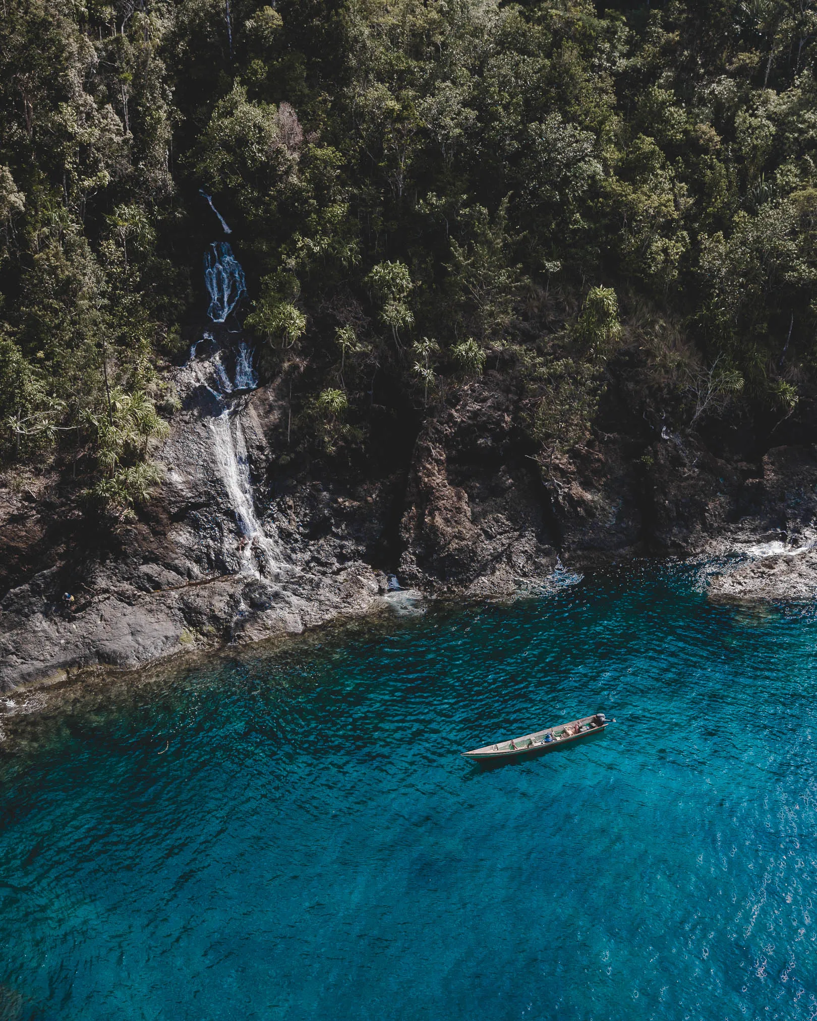 Waterfall cascading directly into the sea on Waigeo Island, Raja Ampat