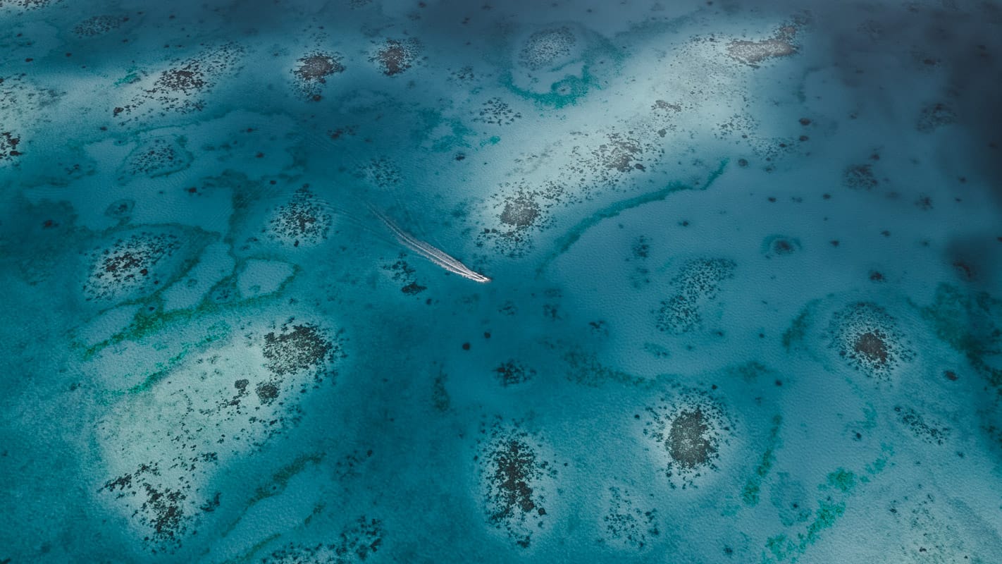 Boat cruising through Ayau's lagoon