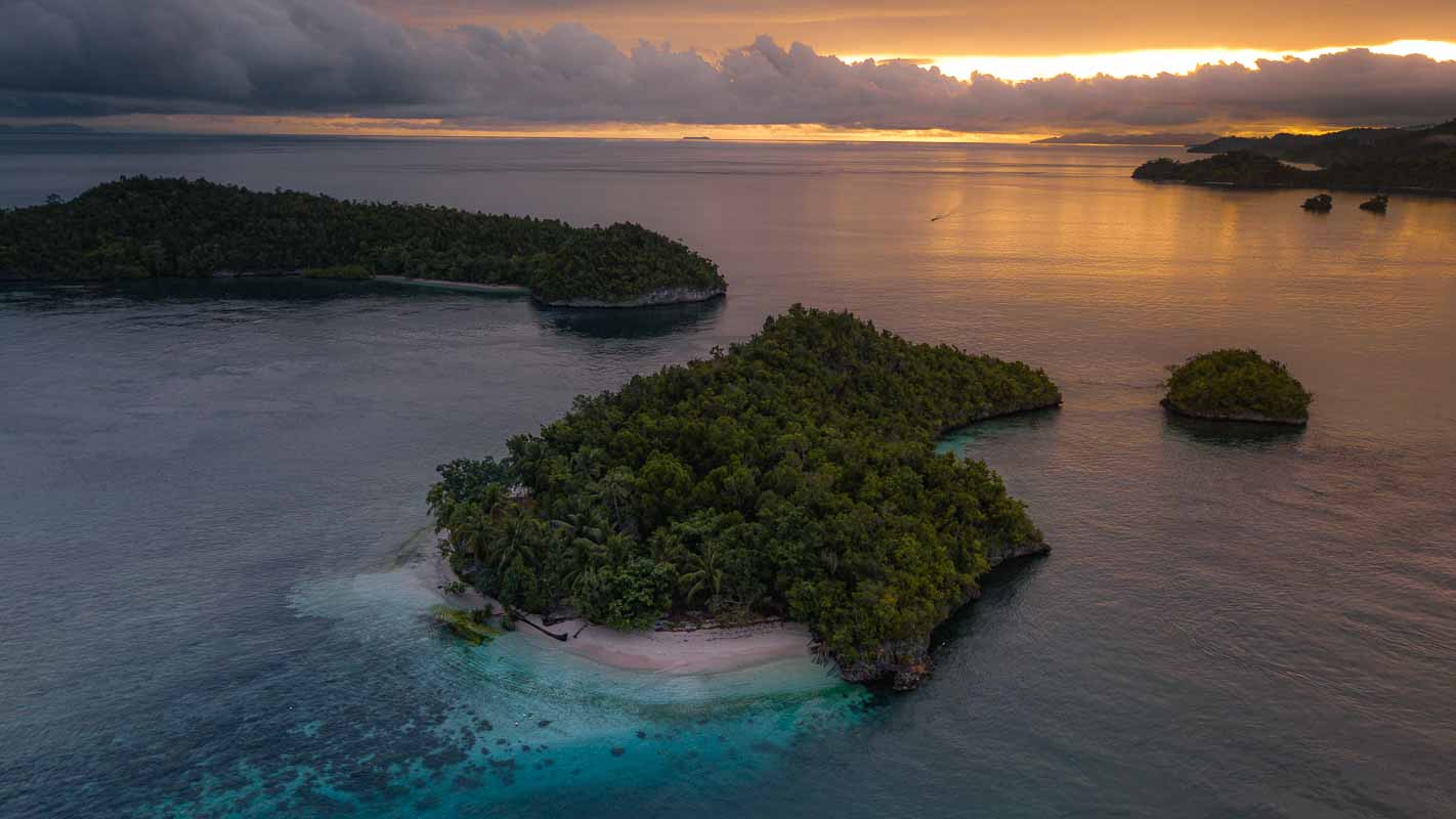 Sun rising over the small islets next to Batanta