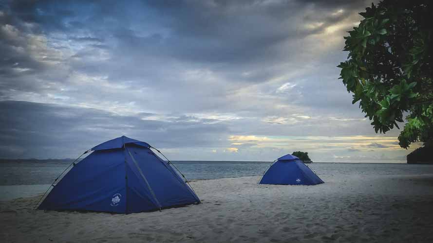 Tents on a white beach in Raja Ampat